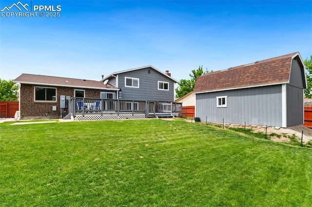 7350 Devinney Ct, Arvada, CO 80005 - back of property with a wooden deck, an outdoor structure, and brick siding