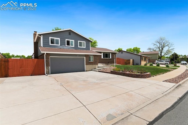7350 Devinney Ct, Arvada, CO 80005 - tri-level home featuring a garage, a chimney, concrete driveway, and brick siding