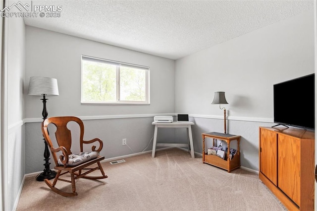 7350 Devinney Ct, Arvada, CO 80005 - sitting room featuring a textured ceiling, light carpet, and baseboards
