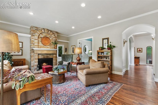 6 3rd St, Colorado Springs, CO 80906 - living area with wood finished floors, a brick fireplace, recessed lighting, baseboards, and ornamental molding
