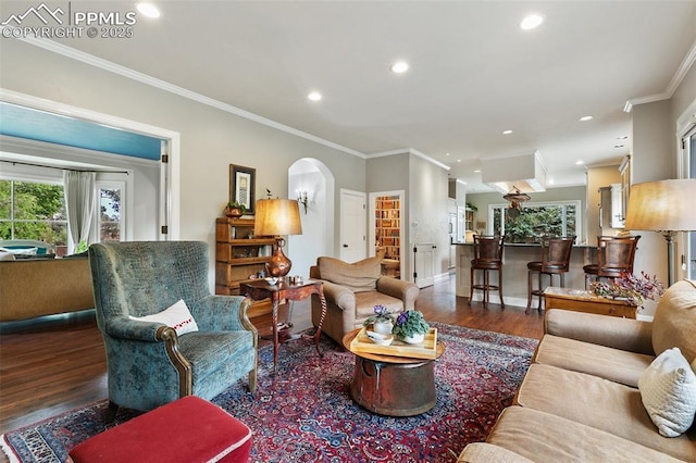 6 3rd St, Colorado Springs, CO 80906 - living room featuring dark wood finished floors, crown molding, arched walkways, recessed lighting, and baseboards