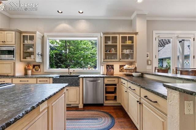 6 3rd St, Colorado Springs, CO 80906 - kitchen featuring appliances with stainless steel finishes, dark wood-style floors, cream cabinetry, a peninsula, and a sink