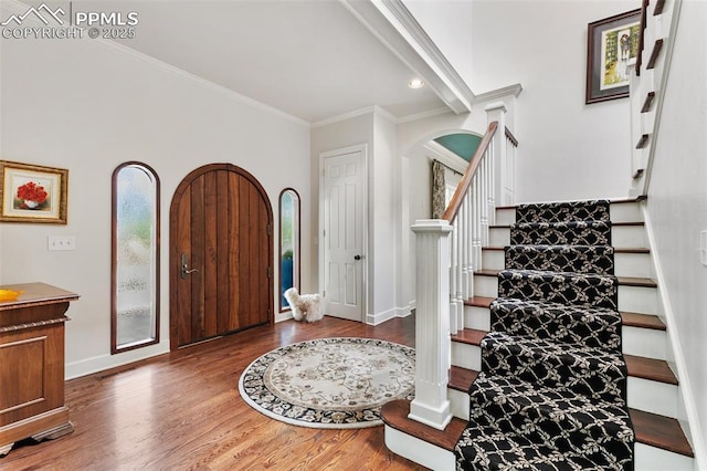 6 3rd St, Colorado Springs, CO 80906 - entrance foyer featuring stairway, arched walkways, baseboards, wood finished floors, and crown molding