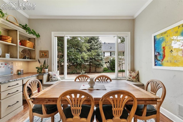 6 3rd St, Colorado Springs, CO 80906 - dining space featuring light wood-style floors, plenty of natural light, crown molding, and baseboards