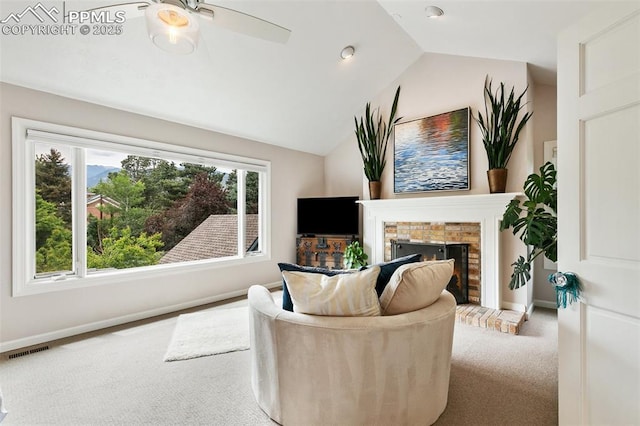 6 3rd St, Colorado Springs, CO 80906 - carpeted living room with baseboards, lofted ceiling, a warm lit fireplace, and a ceiling fan