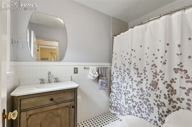 6 3rd St, Colorado Springs, CO 80906 - bathroom featuring toilet, wainscoting, vanity, and a shower with curtain