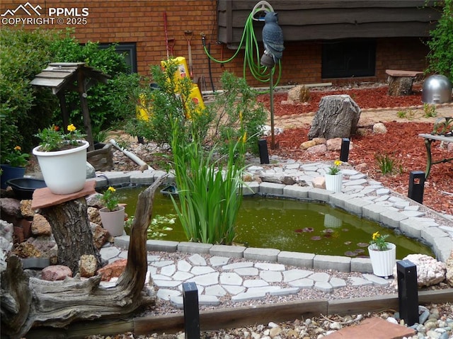 4307 Valli Vista Rd, Colorado Springs, CO 80915 - exterior view of a garden pond and brick siding