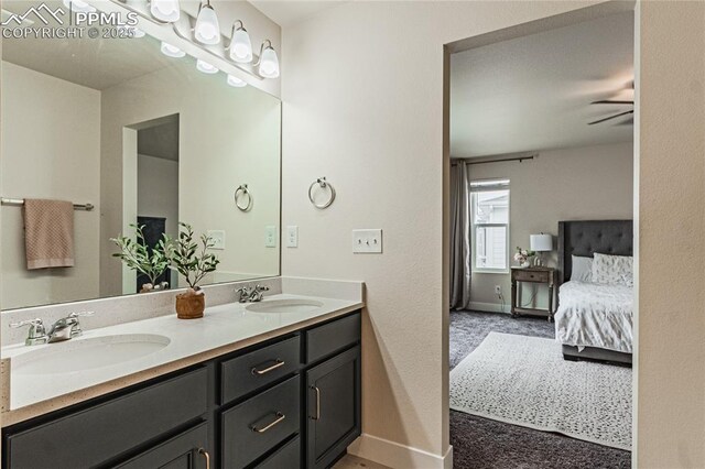 12670 Granite Ridge Dr, Peyton, CO 80831 - ensuite bathroom with double vanity and baseboards