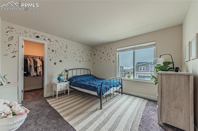 12670 Granite Ridge Dr, Peyton, CO 80831 - carpeted bedroom with a walk in closet, baseboards, and a closet