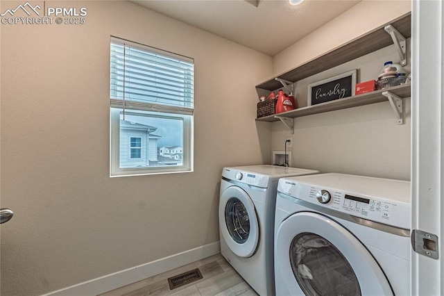 12670 Granite Ridge Dr, Peyton, CO 80831 - laundry room featuring washer and clothes dryer, baseboards, and light wood-style flooring