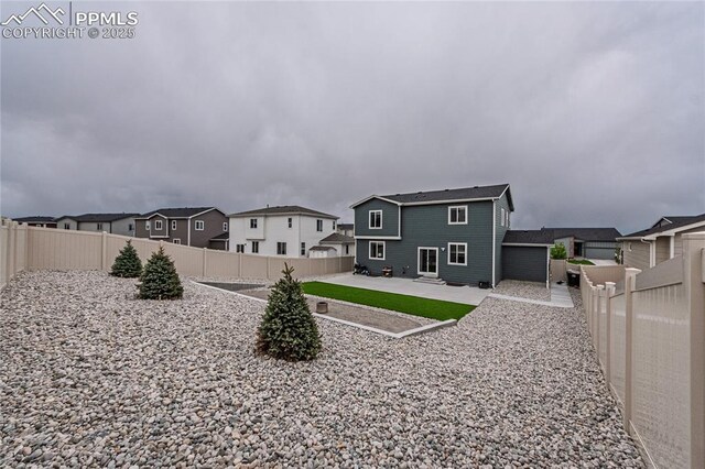 12670 Granite Ridge Dr, Peyton, CO 80831 - back of property with a patio area, a fenced backyard, and a residential view