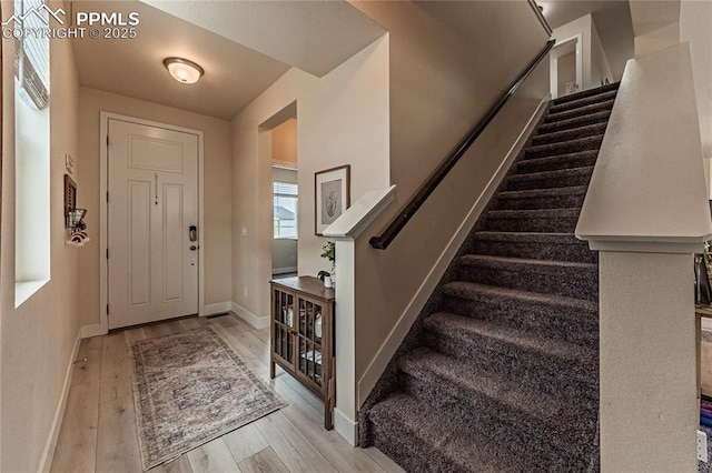 12670 Granite Ridge Dr, Peyton, CO 80831 - entryway featuring wood finished floors, stairs, and baseboards