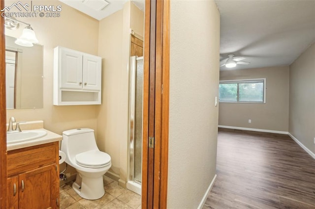 27 Stovel Cir, Colorado Springs, CO 80916 - bathroom featuring vanity, toilet, a stall shower, ceiling fan, and baseboards