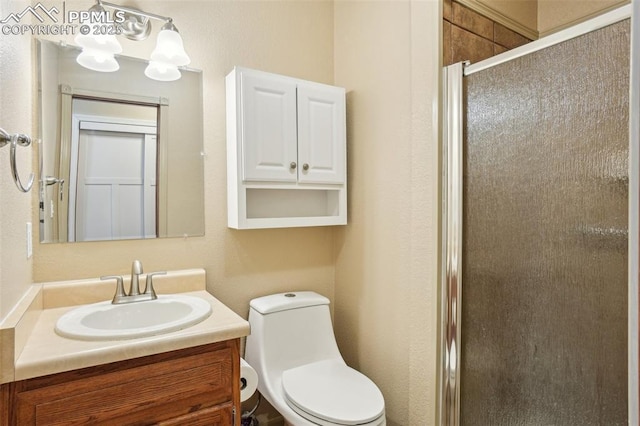 27 Stovel Cir, Colorado Springs, CO 80916 - bathroom featuring a stall shower, vanity, and toilet