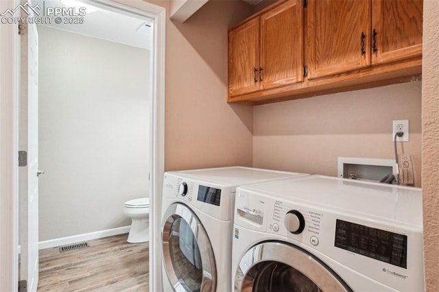 27 Stovel Cir, Colorado Springs, CO 80916 - washroom with washing machine and clothes dryer, light wood finished floors, and baseboards