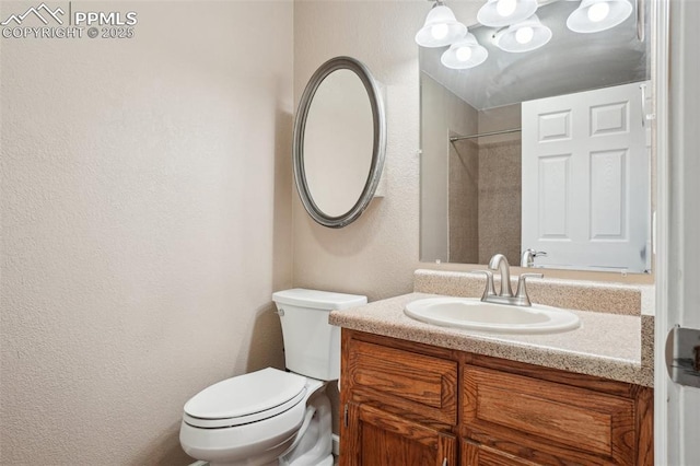 27 Stovel Cir, Colorado Springs, CO 80916 - bathroom with a textured wall, toilet, vanity, and a shower