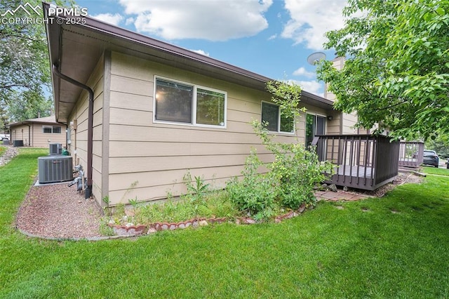 27 Stovel Cir, Colorado Springs, CO 80916 - back of property with a wooden deck, cooling unit, and a yard