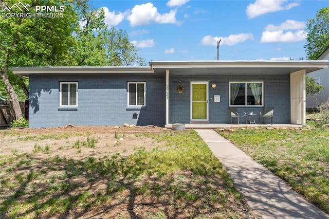 2321 N Meade Ave, Colorado Springs, CO 80907 - ranch-style home with brick siding and a porch