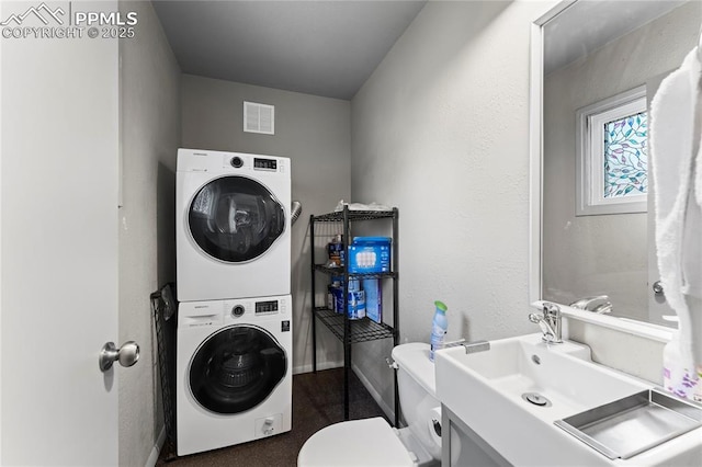 2321 N Meade Ave, Colorado Springs, CO 80907 - laundry room featuring estacked washer and dryer and baseboards