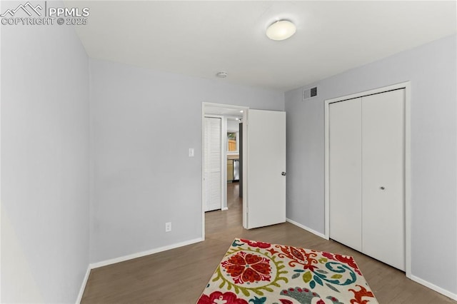 2321 N Meade Ave, Colorado Springs, CO 80907 - bedroom featuring wood finished floors, baseboards, and a closet