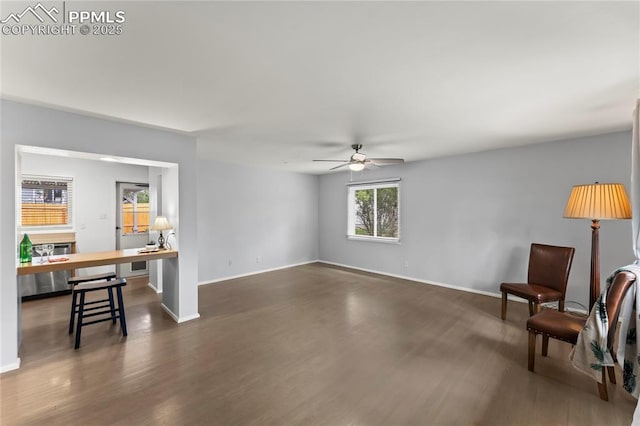 2321 N Meade Ave, Colorado Springs, CO 80907 - unfurnished living room with wood finished floors, a ceiling fan, and baseboards