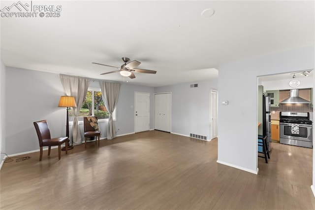 2321 N Meade Ave, Colorado Springs, CO 80907 - living area with ceiling fan, wood finished floors, and baseboards