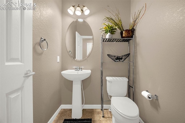 7526 Gallard Hts, Peyton, CO 80831 - half bath featuring toilet, baseboards, and tile patterned floors