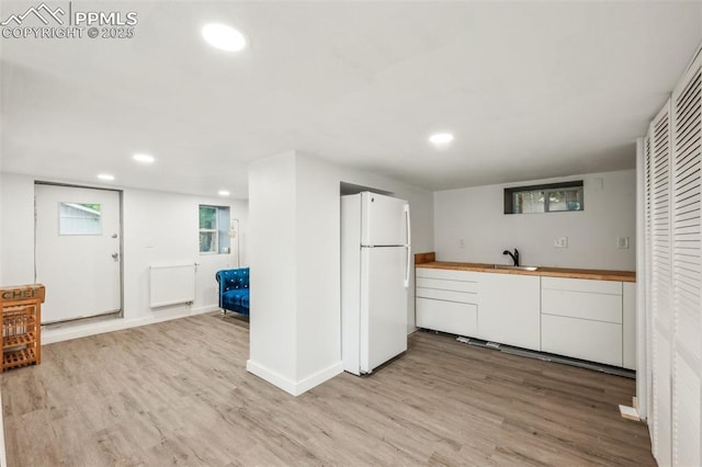 817 W Kiowa St, Colorado Springs, CO 80905 - kitchen with freestanding refrigerator, radiator, light wood-style floors, recessed lighting, and wooden counters