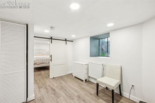 817 W Kiowa St, Colorado Springs, CO 80905 - bedroom with radiator heating unit, light wood-type flooring, a barn door, recessed lighting, and baseboards