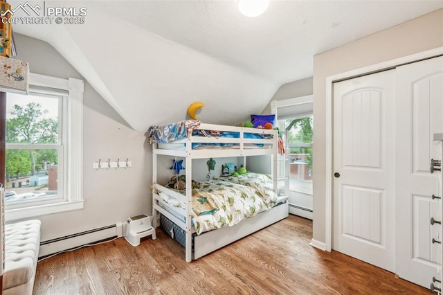 817 W Kiowa St, Colorado Springs, CO 80905 - bedroom with baseboard heating, lofted ceiling, wood finished floors, and a closet