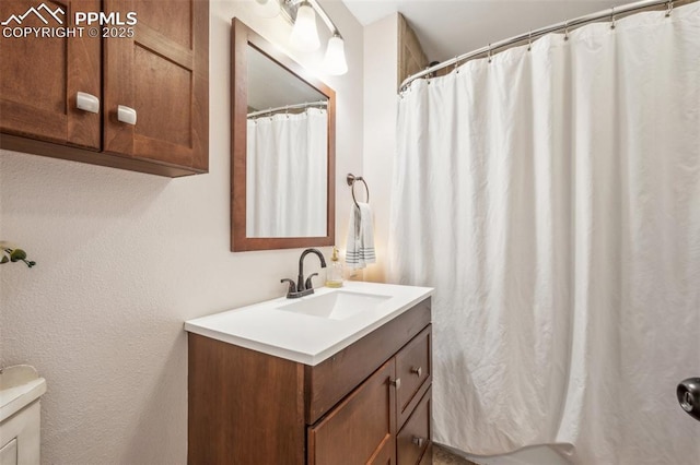817 W Kiowa St, Colorado Springs, CO 80905 - bathroom with vanity, toilet, a shower with curtain, and a textured wall