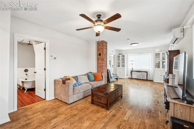 817 W Kiowa St, Colorado Springs, CO 80905 - living area featuring a wall unit AC, wood finished floors, ceiling fan, and baseboards