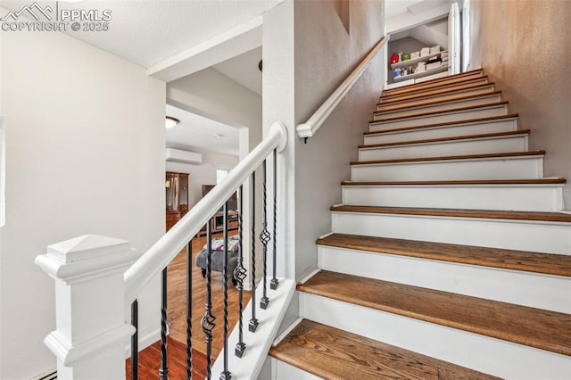 817 W Kiowa St, Colorado Springs, CO 80905 - stairway with a wall mounted air conditioner and wood finished floors