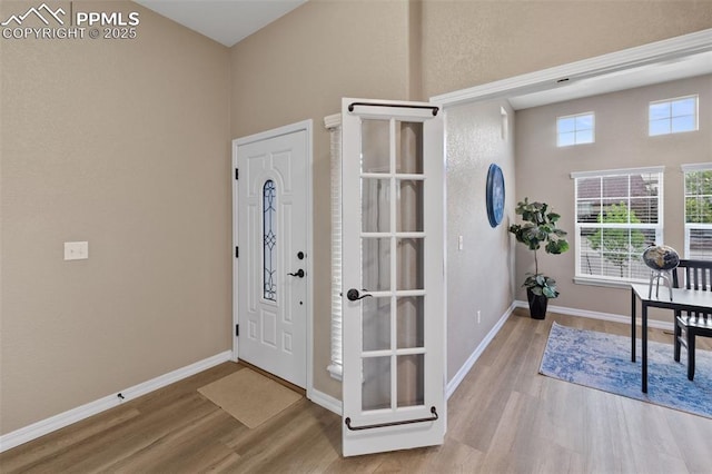 8059 Cinnamon Ct, Colorado Springs, CO 80927 - entryway with wood finished floors, baseboards, and a towering ceiling