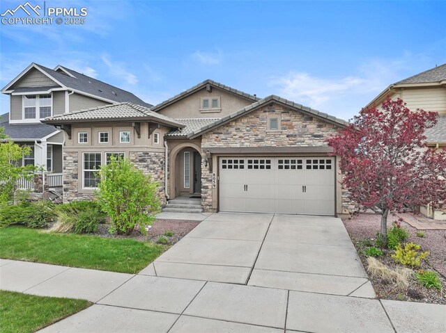 8059 Cinnamon Ct, Colorado Springs, CO 80927 - view of front of house with stone siding, a garage, concrete driveway, and stucco siding