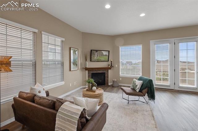 8059 Cinnamon Ct, Colorado Springs, CO 80927 - living area featuring baseboards, wood finished floors, recessed lighting, and a glass covered fireplace