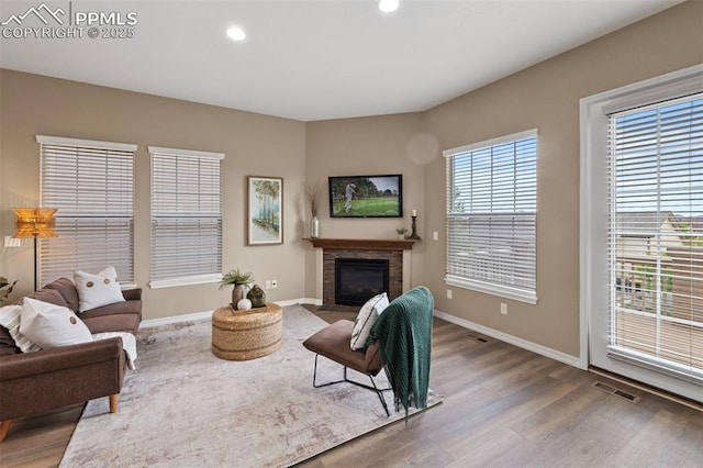 8059 Cinnamon Ct, Colorado Springs, CO 80927 - living room with wood finished floors, plenty of natural light, a fireplace with flush hearth, baseboards, and recessed lighting