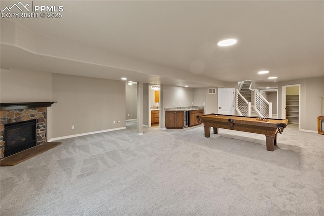 8059 Cinnamon Ct, Colorado Springs, CO 80927 - playroom with bar with sink, light carpet, baseboards, a fireplace, and recessed lighting