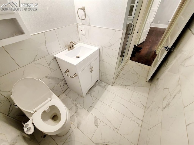 18 S 13th St, Colorado Springs, CO 80904 - bathroom featuring tile walls, vanity, wainscoting, toilet, and a stall shower