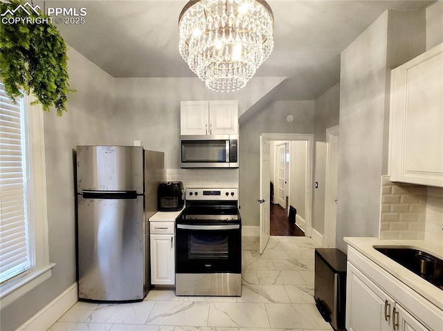18 S 13th St, Colorado Springs, CO 80904 - kitchen with stainless steel appliances, light marble finish flooring, baseboards, and tasteful backsplash