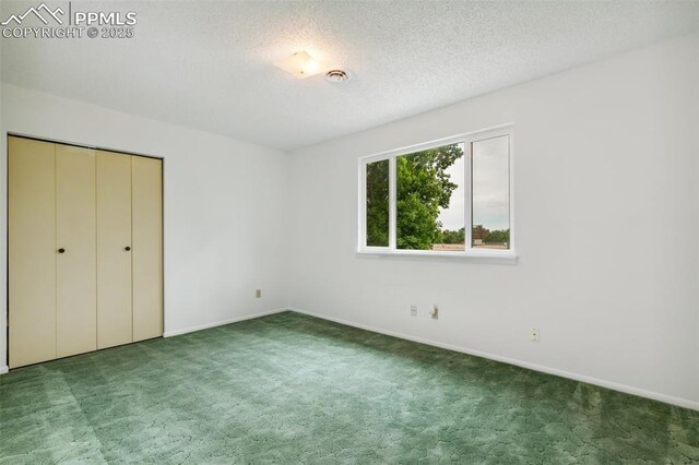 4139 Morley Cir, Colorado Springs, CO 80916 - unfurnished bedroom featuring carpet flooring, baseboards, a textured ceiling, and a closet