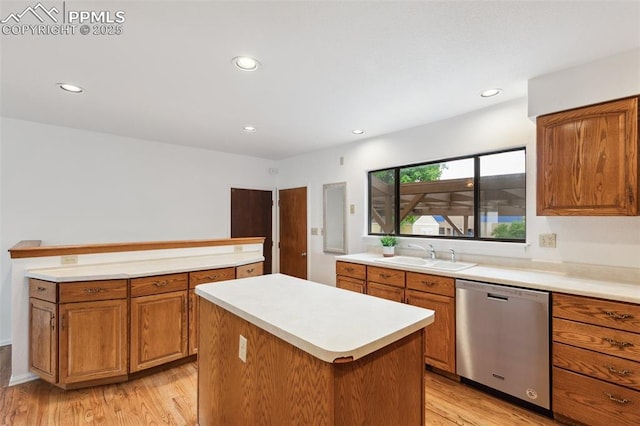 4139 Morley Cir, Colorado Springs, CO 80916 - kitchen with stainless steel dishwasher, a sink, a center island, light wood-style floors, and brown cabinets