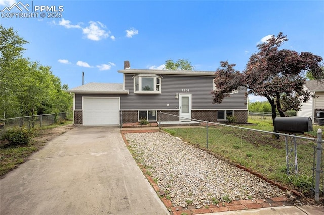 2201 Sonoma Dr, Colorado Springs, CO 80910 - bi-level home with brick siding, a garage, concrete driveway, oil tank, and a chimney