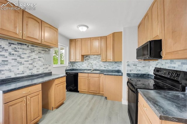 2201 Sonoma Dr, Colorado Springs, CO 80910 - kitchen with black appliances, a sink, light wood-type flooring, and dark countertops