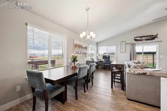 10442 Beckham St, Peyton, CO 80831 - dining room with a chandelier, wood finished floors, lofted ceiling, and baseboards