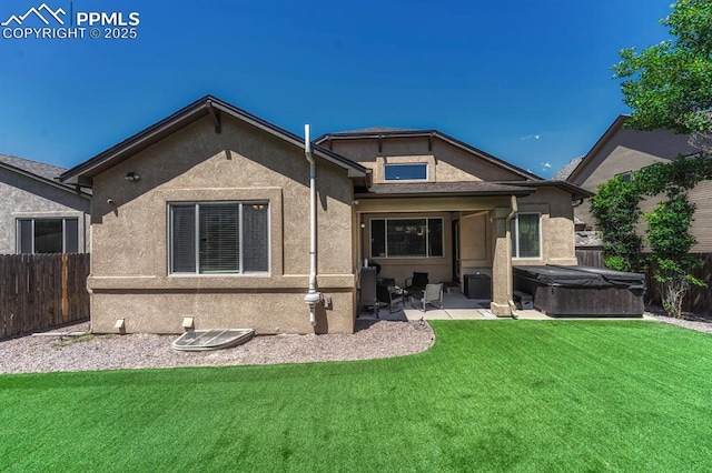 8055 Mount Hayden Dr, Colorado Springs, CO 80924 - back of property with a hot tub, a patio area, a fenced backyard, and stucco siding