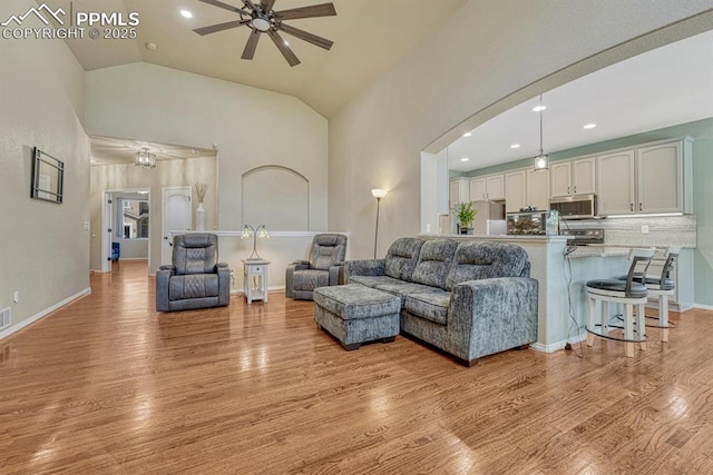 8055 Mount Hayden Dr, Colorado Springs, CO 80924 - living area with a ceiling fan, light wood-style floors, high vaulted ceiling, recessed lighting, and arched walkways