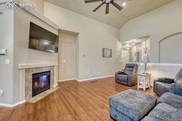 8055 Mount Hayden Dr, Colorado Springs, CO 80924 - living area featuring ceiling fan, wood finished floors, vaulted ceiling, and a fireplace