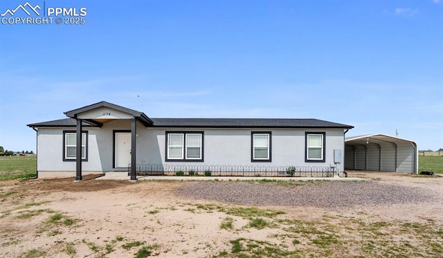 1134 Buffalo Run Rd, Calhan, CO 80808 - ranch-style home featuring driveway, a detached carport, and stucco siding
