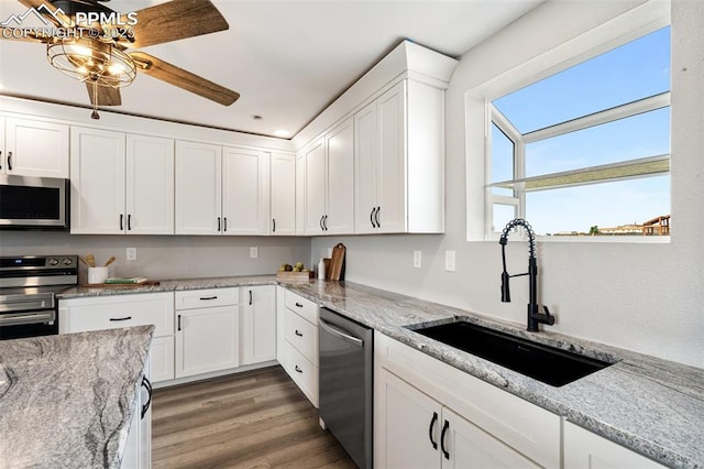 1134 Buffalo Run Rd, Calhan, CO 80808 - kitchen with appliances with stainless steel finishes, a sink, white cabinets, and light wood finished floors